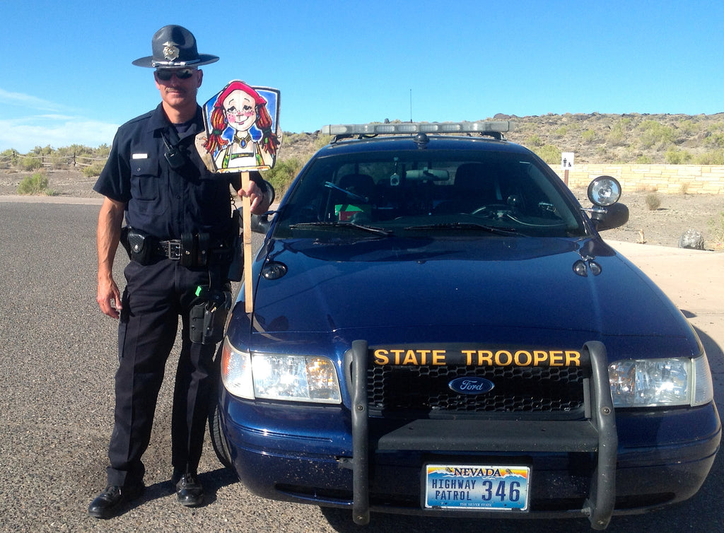 police officer holding cousin mary jane character sign