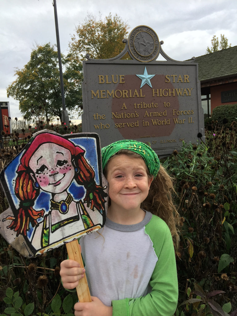 little girl holding cousin mary jane character sign